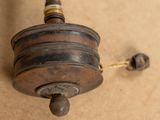 an old spinning device that is on the floor