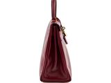 the large burgundy leather bag is open and ready to be used