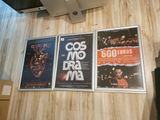 three movie posters on the wall of a room