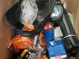 a cardboard box filled with assorted items and a laptop