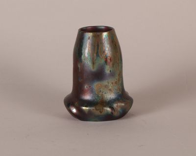 a close up of a vase on a white surface