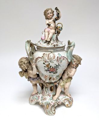 a white vase with a cupid on top of it