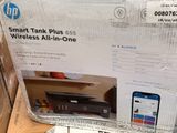 a box that has a printer and a cell phone in it