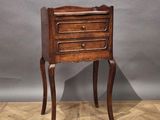 an image of a small wooden table with a drawer on it