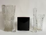three vases sitting next to each other on a white surface