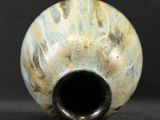 a close up of a vase on a black surface