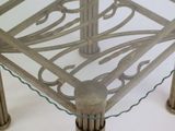 a glass table with metal legs and a glass top