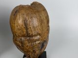 a statue of an apple on a stand next to other sculptures