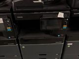 a lot of printers that are sitting on the floor