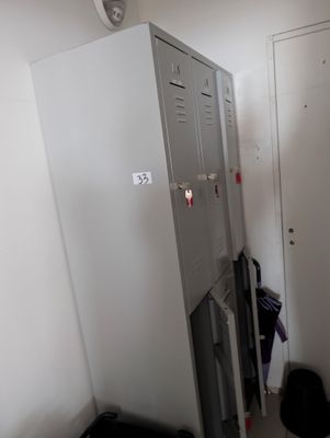 a locker in the corner of a room with a door open