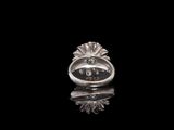 a close up of a silver ring on a black surface
