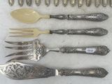 a lot of silverware on a table with spoons and forks