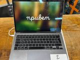 a laptop computer sitting on top of a wooden table