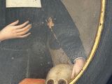 portrait of a nun with a skull in a black frame