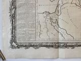 an old map with a pen and a pencil on a table