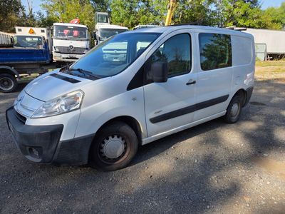 a small white van parked in a parking lot