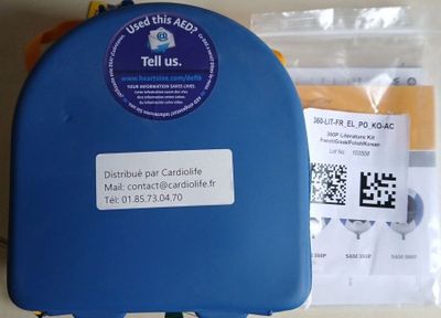 a blue suitcase with a sticker on it sitting on a table