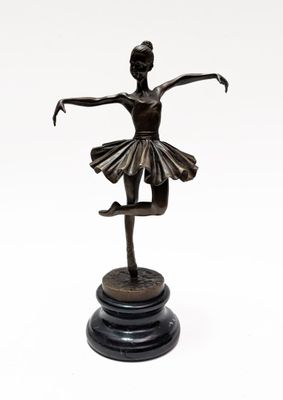 bronze statue of a ballerina on a black marble base