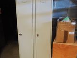 a white locker with a door and some boxes on the floor