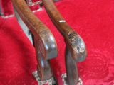 two wooden golf clubs sitting on a red cloth