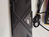 a remote control that is sitting on a table next to a book