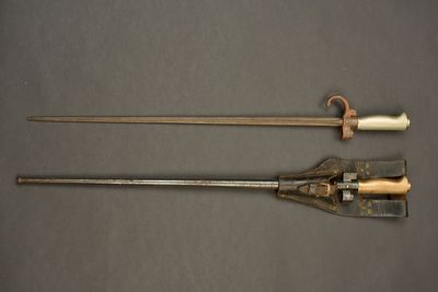 pair of old metal tools sitting on top of a gray surface