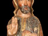 an old wooden statue of a man with a beard and a robe