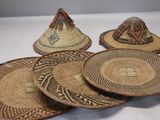 several straw hats are stacked on top of each other on a table