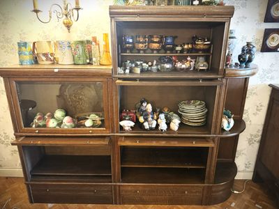 a wooden cabinet with a lot of items on top of it