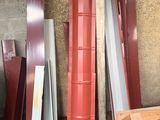 Plusieurs morceaux de métal rouge et blanc sont empilés dans un garage