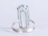 an image of a ring with a blue topazt stone in it