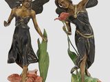 two figurines of two women with wings and flowers