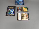several video games on a table with a box of cards