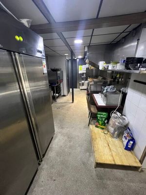a kitchen with stainless steel appliances and a wooden counter