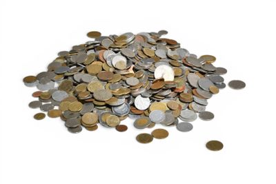 a pile of coins sitting on top of a white surface