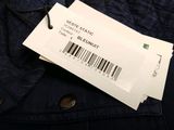 a close up of a label on a jacket with a barcode on it