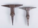 pair of antique hammers on a white surface with a white background