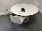 a white table with two chairs and a fan on it