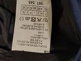a label on the back of a blue jacket
