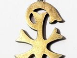 an image of a gold cross pendant on a white background