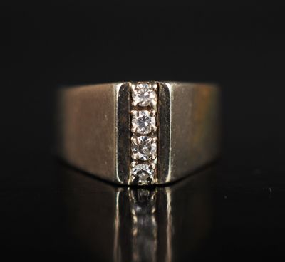 a close up of a gold ring with three diamonds on a black surface