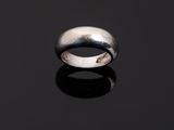 a close up of a silver ring on a black surface