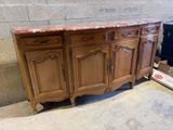 a large wooden cabinet that has a marble top on it