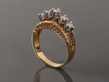 a close up of a gold ring with diamonds on a reflective surface