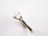 a close up of a diamond ring on a white surface