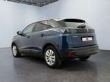 the rear end of a blue car parked in a garage