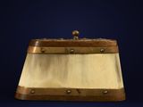 an old wooden box with a metal handle on a blue background