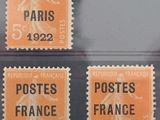 four different postages from france on display in a display case