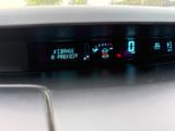 a car dashboard with a digital clock on it