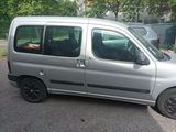 a silver van that is parked in a parking lot
